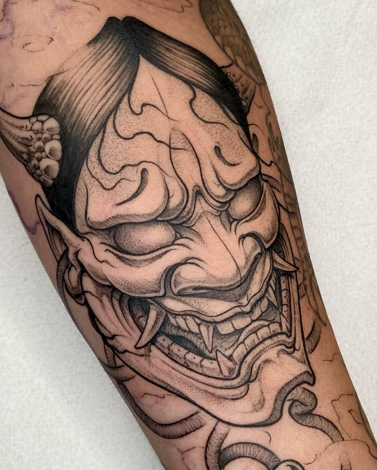 Máscara hannya japonesa en el antebrazo